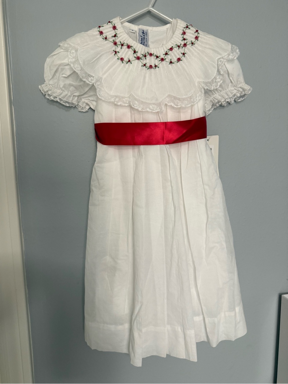 White Smocked Girls' Dress with Red Satin Sash